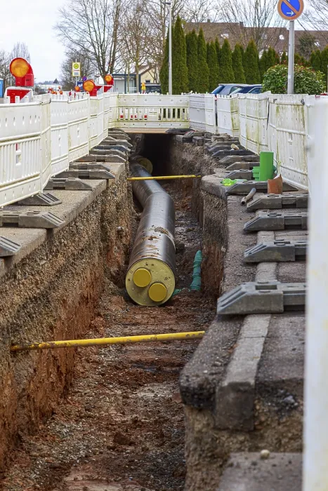Framed Print : Construction trench with installed district heating pipes and barriers in an urban area