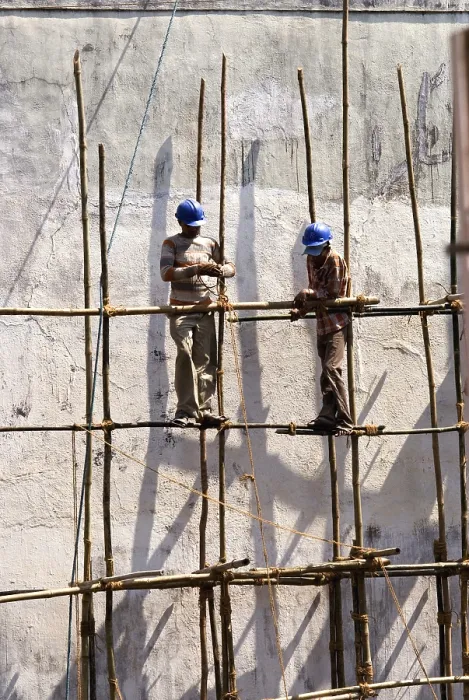 Framed Print : Construction workers tying bamboos with rope