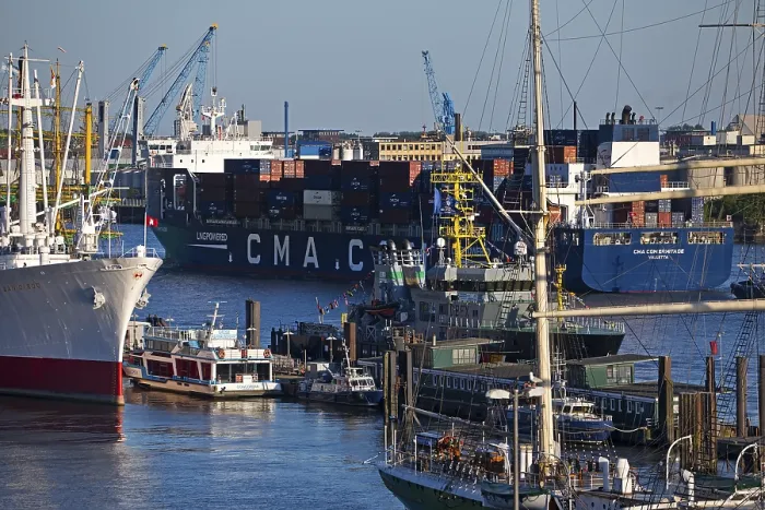 Framed Print : Container ship of the shipping company CMA CGM with many different ships in the port of Hamburg