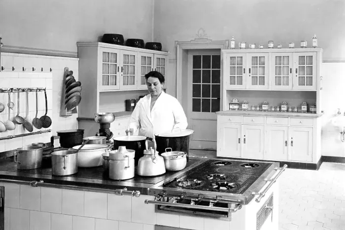 Framed Print : Cook in a large kitchen, ca. 1930s