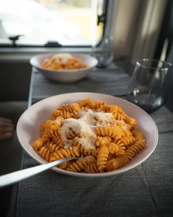 Framed Print : Cooked fusilli with tomato sauce and parmesan cheese on the table in the campervan