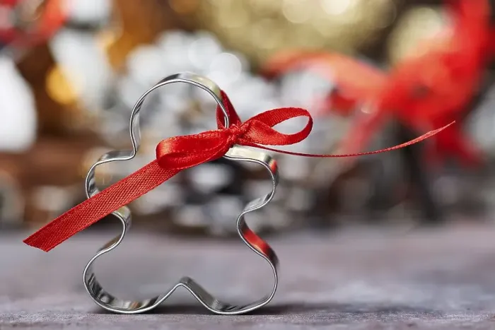 Framed Print : Cookie Cutter with Red Bow in Front of Christmas Decoration Framed Print : Cookie Cutter with Red Bow in Front of Christmas Decoration