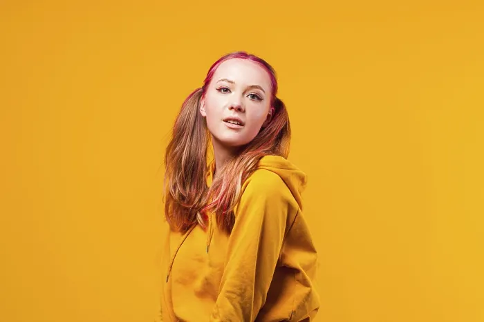 Framed Print : Cool young woman posing in yellow hoodie