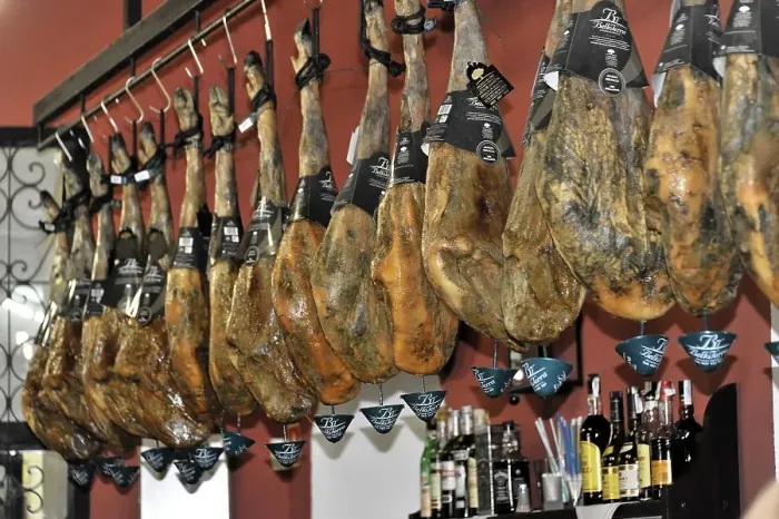 Framed Print : Cordoba, row of Iberian hams hanging in a Spanish restaurant