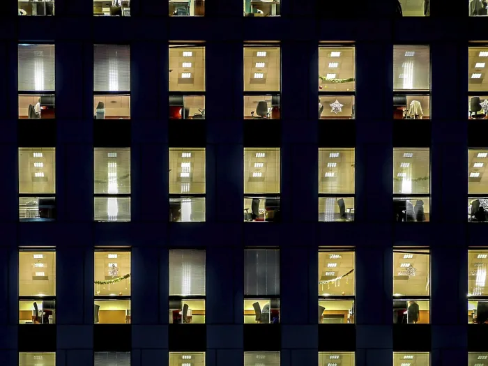 Framed Print : Corporate building exterior in the late eveing with interior lights