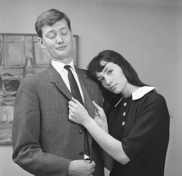 Framed Print : Couple in the 1950s. A young couple pictured at home where she is show affection for him but he is not interested