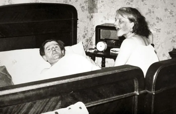 Framed Print : Couple in bedroom, man is lying in bed