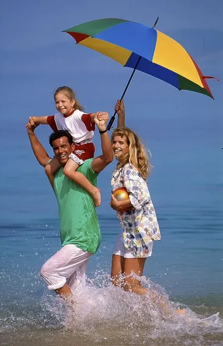 Framed Print : Couple with child and parasol in the sea, beach