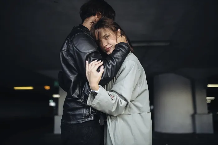 Framed Print : A couple in a comforting embrace in a subdued setting Framed Print : A couple in a comforting embrace in a subdued setting