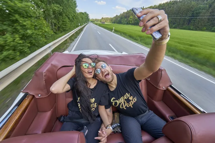 Framed Print : A couple in a convertible takes a selfie on a sunny road trip Framed Print : A couple in a convertible takes a selfie on a sunny road trip