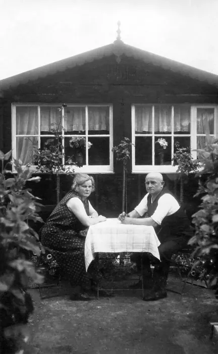 Framed Print : Couple, older couple sitting in the allotment garden at the table in front of the arbour