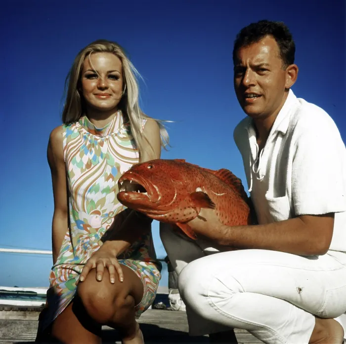 Framed Print : Couple posing with a trout grouper (Plectropomus pessuliferus)
