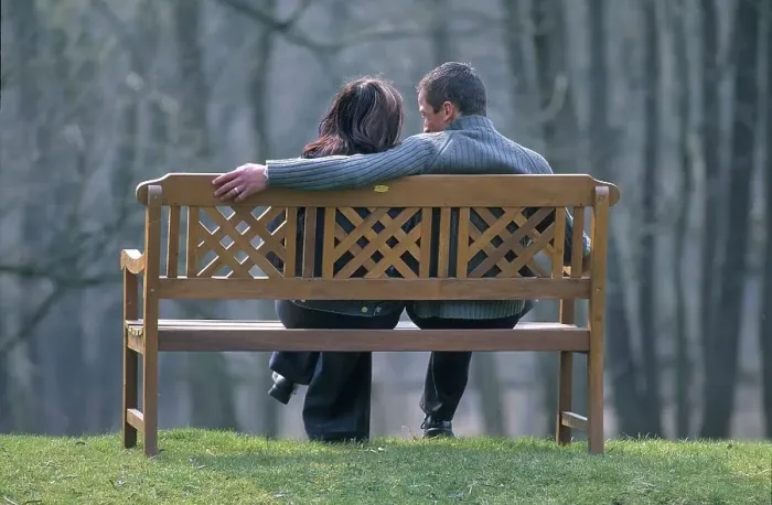 Framed Print : Couple sitting on park bench Framed Print : Couple sitting on park bench
