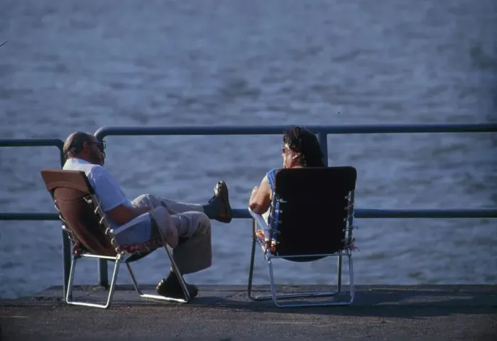 Framed Print : Couple sitting by the sea