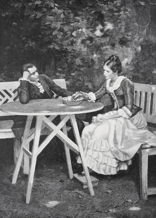 Framed Print : A couple sitting at a table in the garden having a conversation