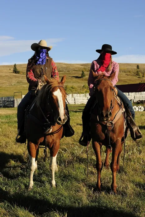 Framed Print : Cowgirls with handkerchiefs over their faces sitting on horses Framed Print : Cowgirls with handkerchiefs over their faces sitting on horses