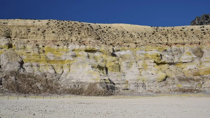Framed Print : Crater wall with layers of yellow and beige rock under a blue sky Framed Print : Crater wall with layers of yellow and beige rock under a blue sky