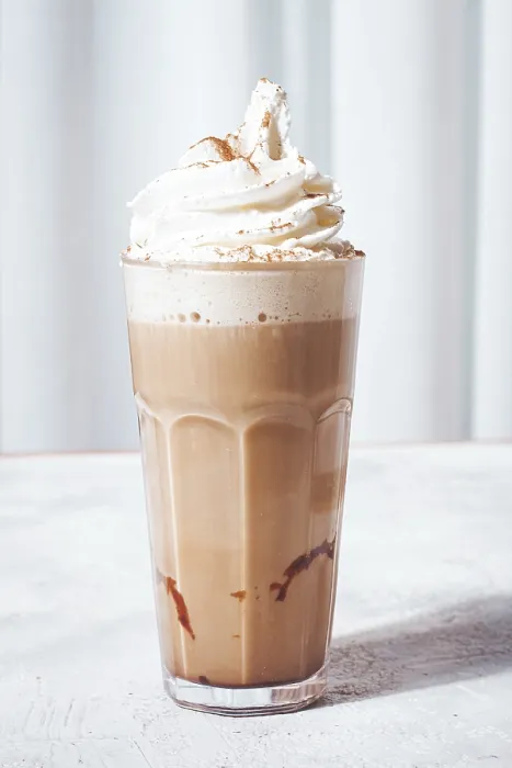 Framed Print : Creamy iced coffee, topped with whipped cream and cinnamon Framed Print : Creamy iced coffee, topped with whipped cream and cinnamon