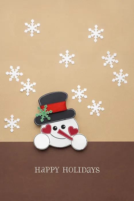 Framed Print : Creative photo of a paper snowman on a brown background