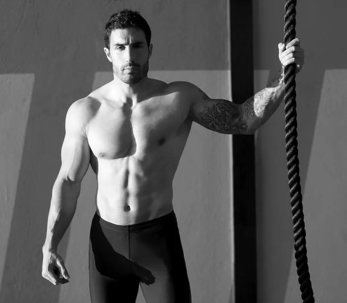 Framed Print : Crossfit gym handsome man holding hand a climbing rope