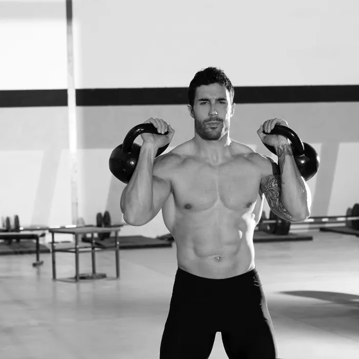 Framed Print : Crossfit man lifting kettlebell workout exercise at gym