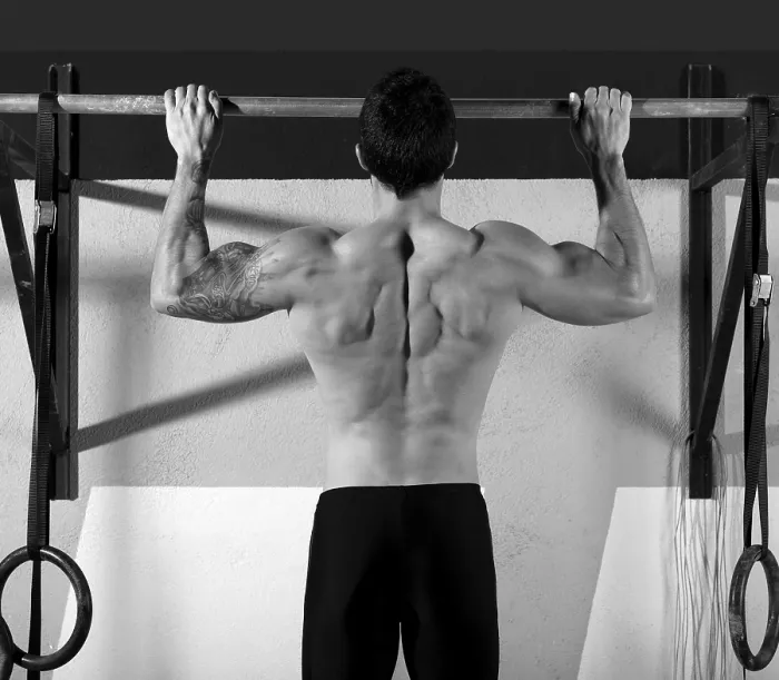 Framed Print : Crossfit toes to bar man pull-ups 2 bars workout exercise at gym