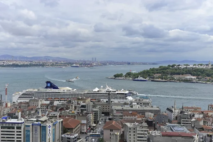 Framed Print : Cruise ship at the harbour with city view and cloudy horizon