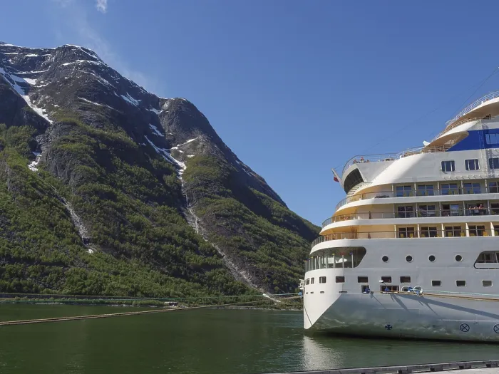 Framed Print : A cruise ship against a majestic mountain backdrop with a clear blue sky