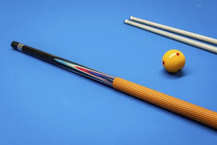Framed Print : Cue sticks and a yellow ball on a billiard table