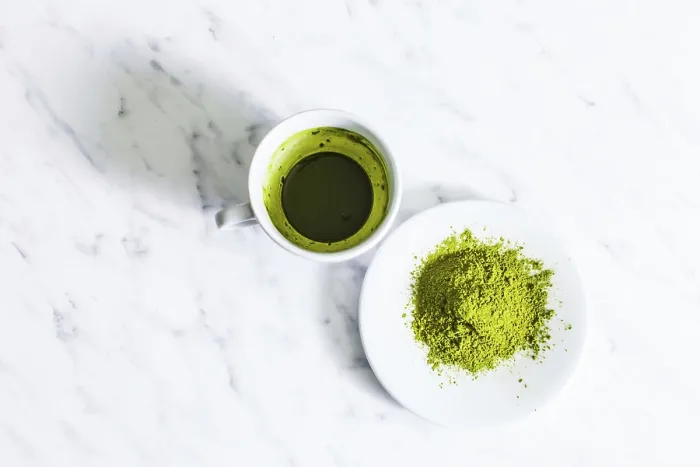 Framed Print : A cup of green matcha tea with matcha powder tea isolated on a light background Framed Print : A cup of green matcha tea with matcha powder tea isolated on a light background