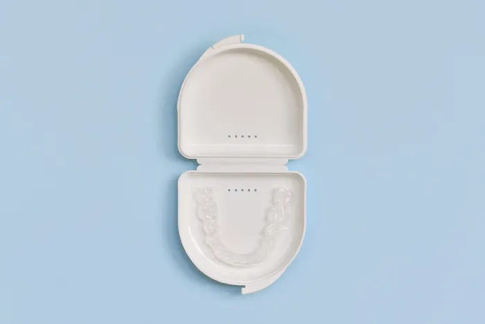 Framed Print : Customized transparent dental teeth bite guard clear aligners for lower jaw in white case on blue background