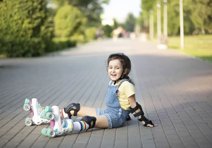 Framed Print : Cute little girl in protective equipment and rollers sitting on walkway in park outdoor Framed Print : Cute little girl in protective equipment and rollers sitting on walkway in park outdoor