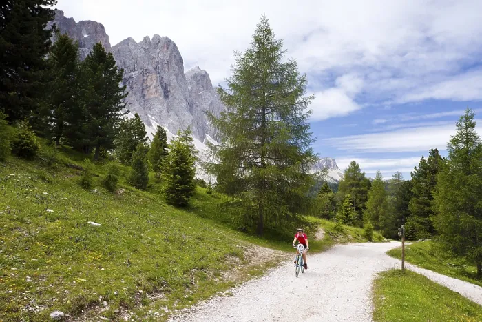 Framed Print : Cyclist beneath Mt Geislerspitzen in Villnoesstal valley Framed Print : Cyclist beneath Mt Geislerspitzen in Villnoesstal valley