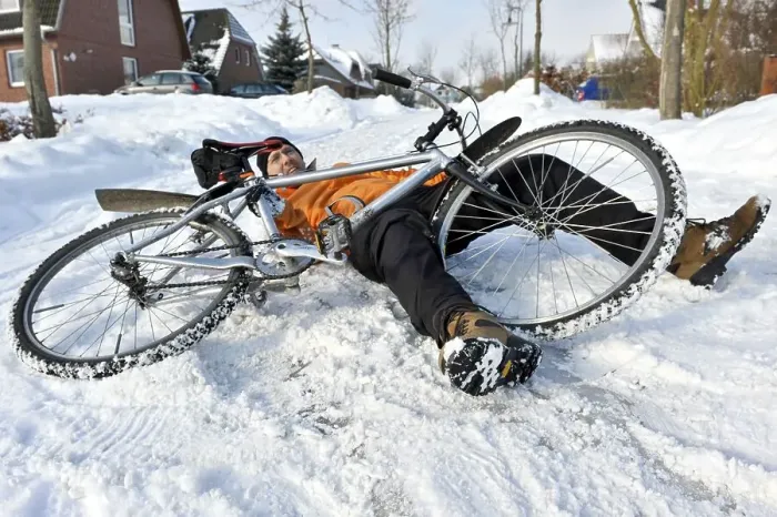 Framed Print : Cyclist crashing on a snow-covered slippery road