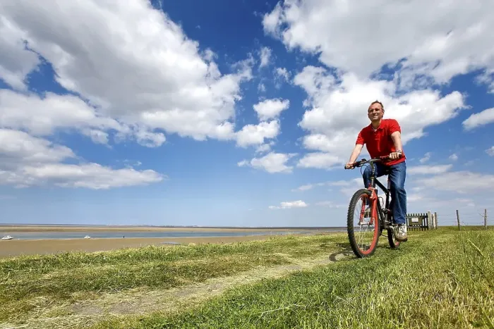 Framed Print : Cyclist on a dike, Foehr, North Frisia