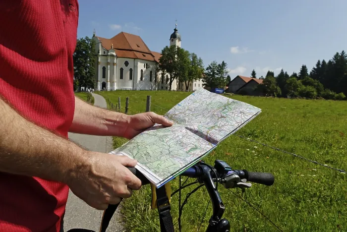 Framed Print : Cyclist holding a map, in the back Wies