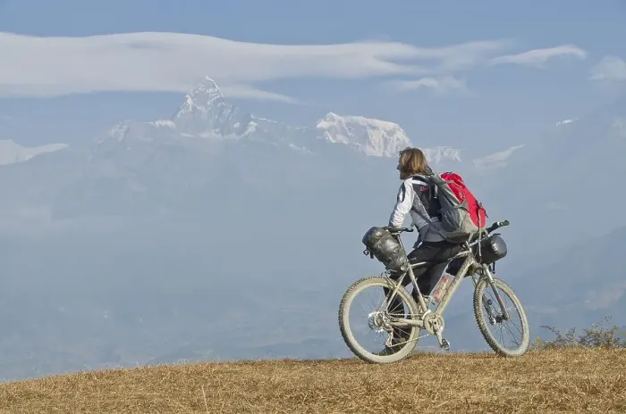 Framed Print : Cyclist leaning on his bike, looking towards Annapurna range