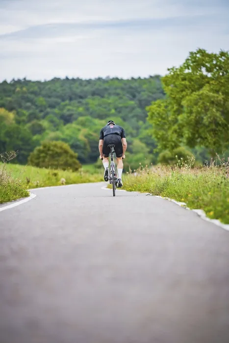 Framed Print : A cyclist rides on a remote road through nature