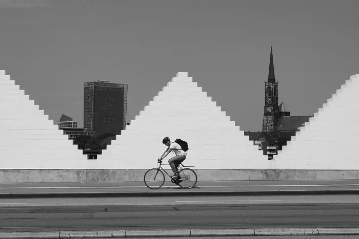 Framed Print : Cyclist in front of white wall