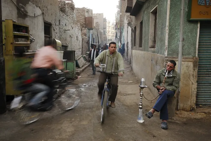 Framed Print : Cyclists and an Egyptian man smoking a water pipe