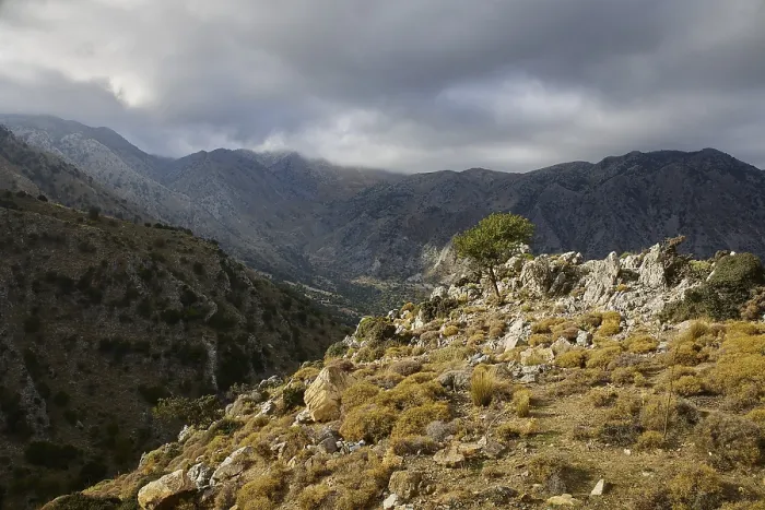 Framed Print : Dark cloud cover hangs over a wild mountain landscape