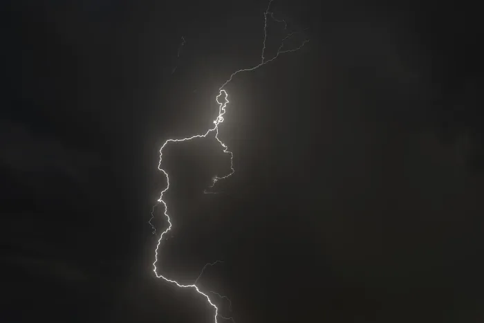 Framed Print : Dark clouds gather as lightning strikes light up the night