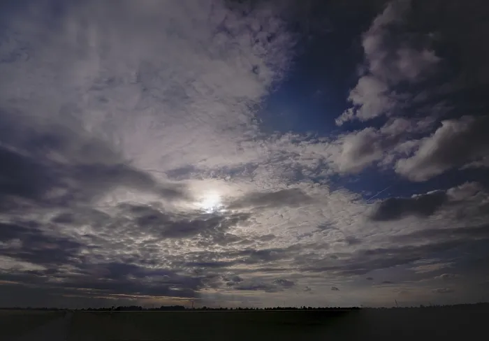 Framed Print : Dark clouds in the sky with sun in the backlight