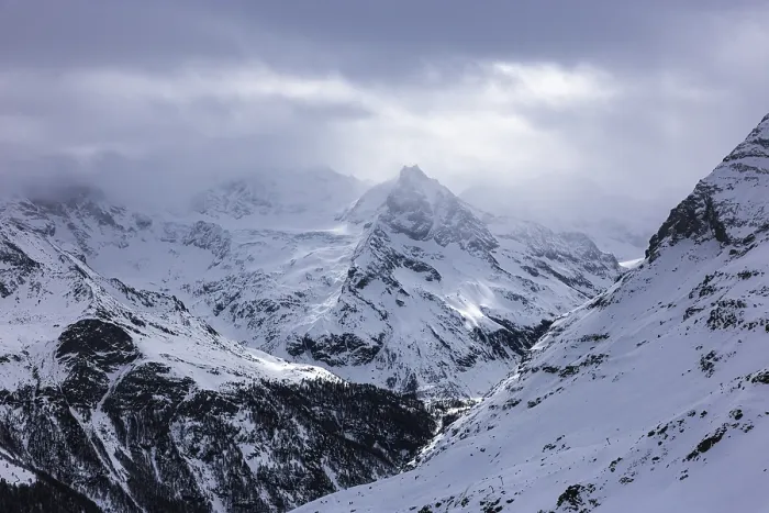 Framed Print : Dark clouds and wafts of mist surround the snow-covered summit of Mount Le Besso Framed Print : Dark clouds and wafts of mist surround the snow-covered summit of Mount Le Besso