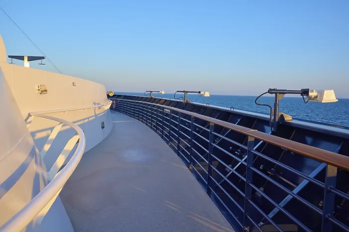 Framed Print : Deck of a cruise ship with clear blue sky and blue railing