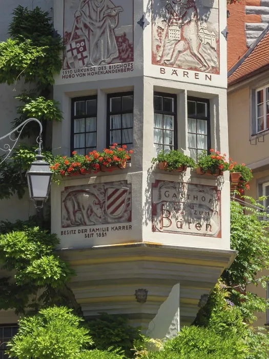 Framed Print : A decorated half-timbered house with murals and red geraniums in full bloom Framed Print : A decorated half-timbered house with murals and red geraniums in full bloom