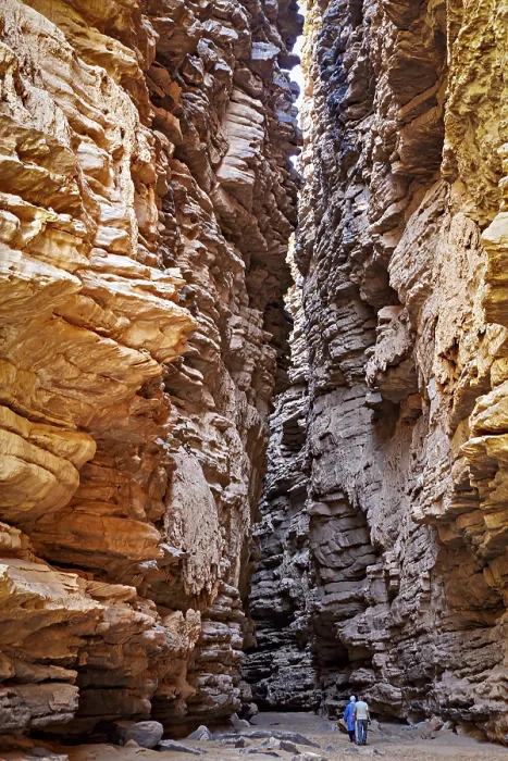 Framed Print : Deep, narrow gorge with dramatic incidence of light and a person surrounded by rocky walls