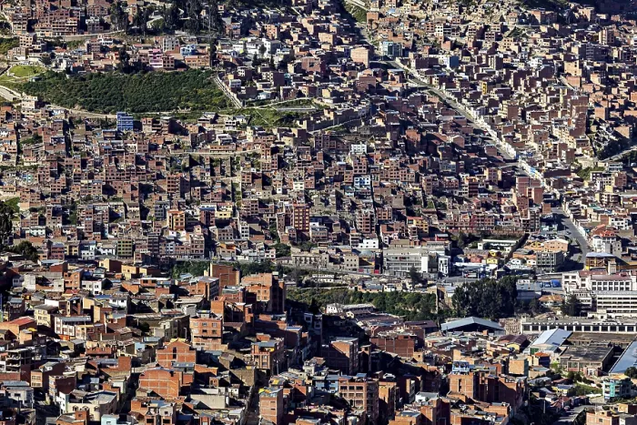 Framed Print : Dense urban development with many brick buildings in hilly surroundings