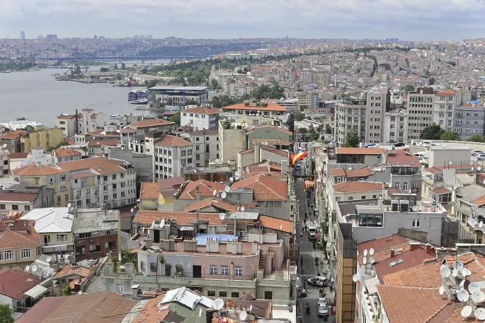 Framed Print : Dense urban development with red roofs and river in the background
