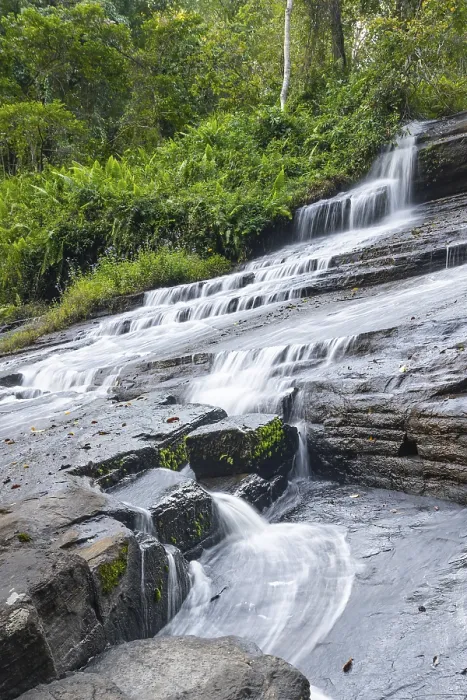 Framed Print : Derema Waterfall flows through thick vegetation